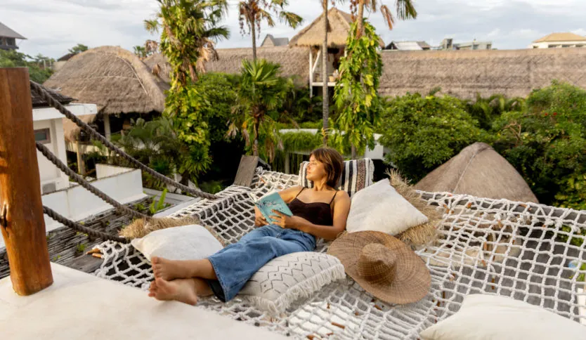 Guest relaxing in hammock at resort